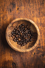 Roasted coffee beans in wooden bowl
