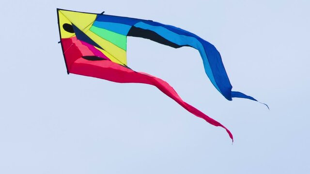 Kite with Colorful Tails. Bright multicolored kite gaily fluttering against the sky. Filmed at a speed of 120fps