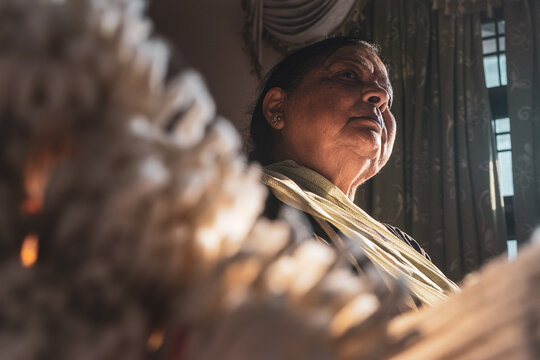 Old Indian Woman Sitting At Home Under The Sunlight