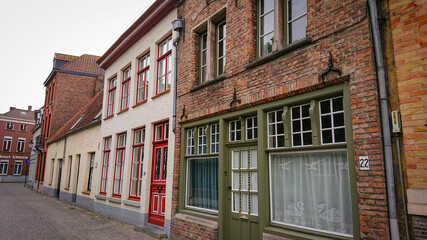 Bruges, Belgium - May 12, 2018:  Roofs And Windows Of Old Authentic Brick Houses On Street Moerstraat