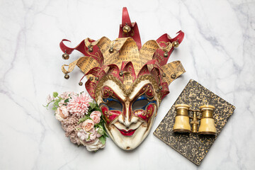 Venetian mask with a book and theater binoculars