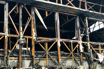 Close up image of burned down wooden house.