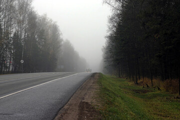 the road on a foggy autumn morning