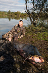 Naklejka premium Fisherman holding a giant catfish. Catch of fish, freshwater fishing, monster fish
