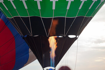 high flame and black green balloon, in the background white blue red balloon