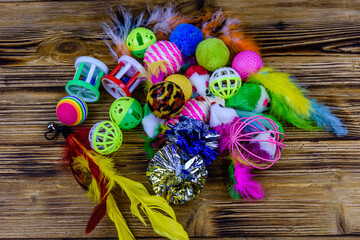 Heap of different toys for cat on a wooden background