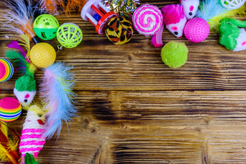 Heap of different toys for cat on a wooden background. Top view