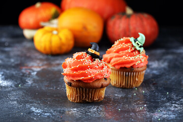 halloween cupcake and pumpkin on a dark background. sweets with cupcakes for the celebration of spooky Halloween.
