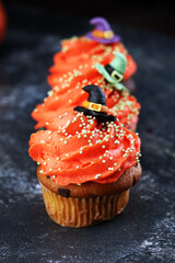 halloween cupcake and pumpkin on a dark background. sweets with cupcakes for the celebration of spooky Halloween.