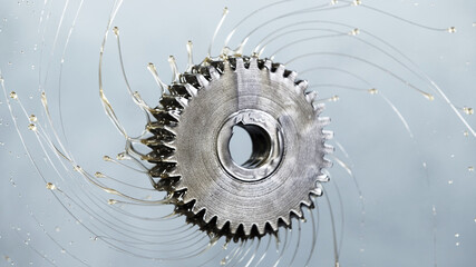 Tooth gear wheel with oil splash - obrazy, fototapety, plakaty