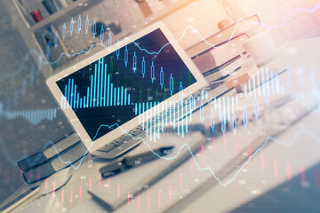 Stock market graph and table with computer background. Multi exposure. Concept of financial analysis.