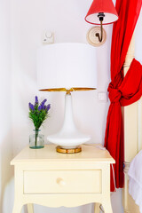 Side table with whitee lamp in the bedroom