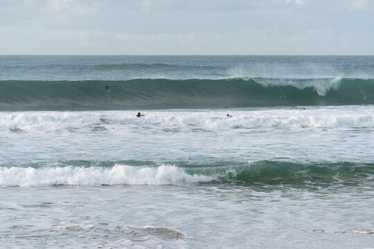 Surfers surfing in Baleal Island beach atlantic ocean waves in Peniche, Portugal