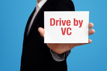 Drive by VC. Businessman in suit showing business card with text. Man isolated on blue background