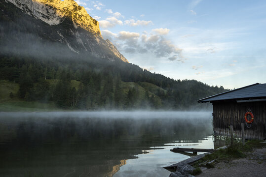 Amazing shot of a wooden house in the Ferchensee lake in Bavaria, Germany