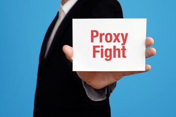 Proxy Fight. Businessman in suit showing business card with text. Man isolated on blue background