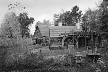 The Saugus Iron Works Forge and Slitting Mill surrounded by colorful fall foliage - B&W