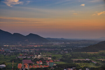 This unique photo shows the sunset in late October over the Thai seaside town called Hua Hin. you can see the houses and mountains very well.
