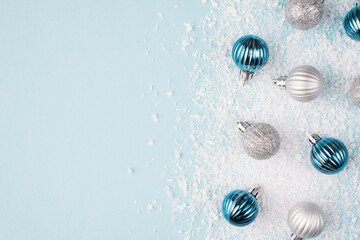 Above overhead close up flatlay photo picture of small beautiful seasonal tree decoration on snow pastel light color background with place for text