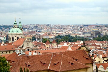 Fototapeta na wymiar Prague skyline with its orange tiled roofs and many spires