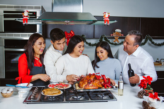 Mexican Family Enjoying Turkey Preparation On  Christmas Holidays 