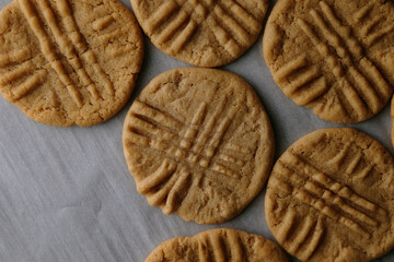 Old homemade peanut butter cookies on baking sheet.