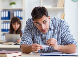 Students sitting and studying in classroom college