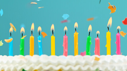 Birthday cake with candles on pastel blue background