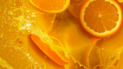Freeze motion of pouring orange juice. Top view, close-up.