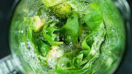 Green fresh smoothie blended in blender, top view. Healthy eating concept.