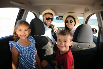 Fototapeta na wymiar Happy family in car on road trip