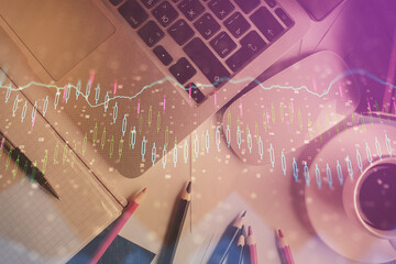 Double exposure of financial chart drawing over table background with computer. Concept of research and analysis. Top view.