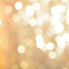 golden backdrop, christmas bokeh lights. abstract refocused blurred background.