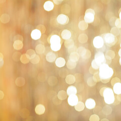 golden backdrop, christmas bokeh lights. abstract refocused blurred background.