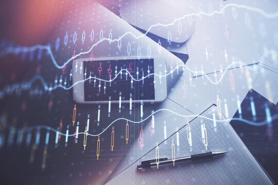 Multi exposure of forex graph hologram over desktop with phone. Top view. Mobile trade platform concept.