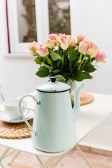Vintage enamel tea pot pale blue with bouquete of pink roses