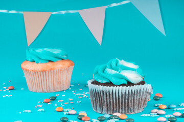 Gourmet colorful cupcakes topped with blue buttercream frosting