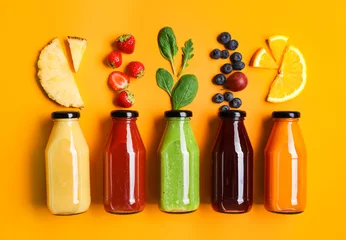 Foto op Aluminium Flat lay composition with bottles of delicious juices and fresh ingredients on orange background © New Africa