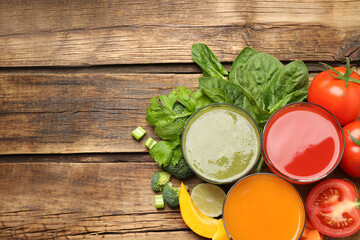 Delicious vegetable juices and fresh ingredients on wooden table, flat lay. Space for text