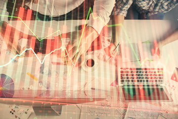 Double exposure of man and woman working together and financial chart hologram drawing. market analysis concept. Computer background. Top View.