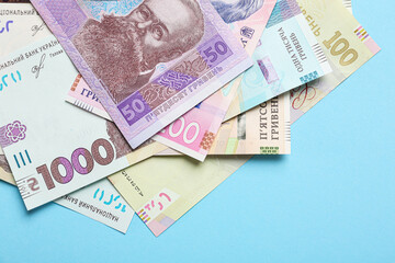 Ukrainian money on light blue background, flat lay