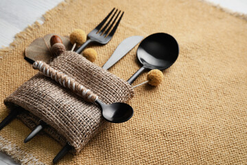 Autumn place setting with cutlery on white table, closeup. Space for text