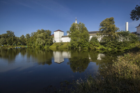 Beautiful view of St. Pafnutiev Borovsky Monastery in Russia with a reflection on a lake water