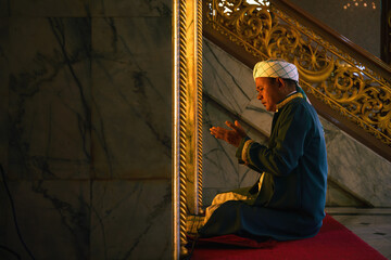 Fototapeta premium muslim man having worship and praying in islam ceremony in mosque