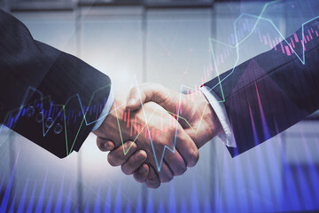 Double exposure of forex graph hologram and handshake of two men. Stock market concept.