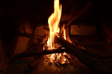 Warm fire and sparks in a fire-place from conflagrant wooden logs
