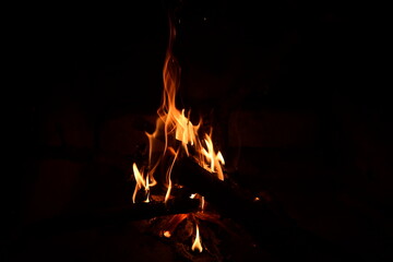 Warm fire and sparks in a fire-place from conflagrant wooden logs