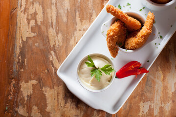 Top view of fried shrimp, white sauce, red hot chilli pepper on wooden table © Patricia Soransso