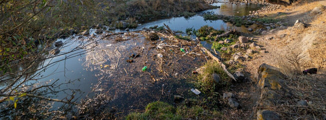Environmental problem. Plastic waste in the river, pollution and the environment in the water.