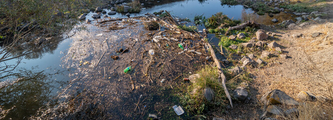 Environmental problem. Plastic waste in the river, pollution and the environment in the water.
